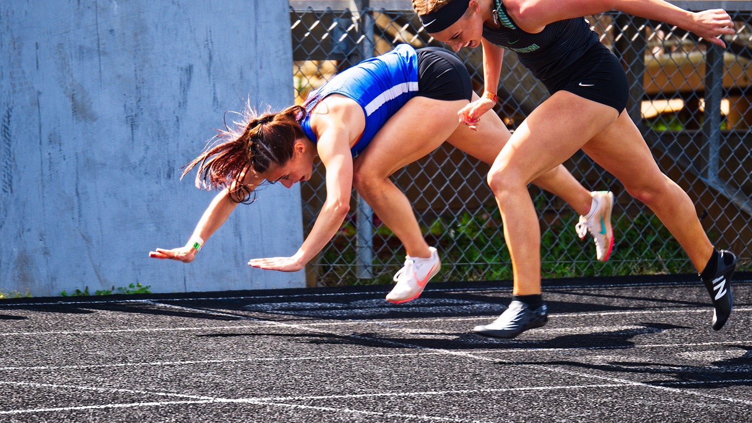 Quitman hurdler Brooklyn Marcee dives over the finish line to edge out Valley View's Rylee Gattenby for second place by one one-hundredth of a second in the 300 meter hurdles at region April 24, earning a trip to Austin. [see more sports from throughout the year]